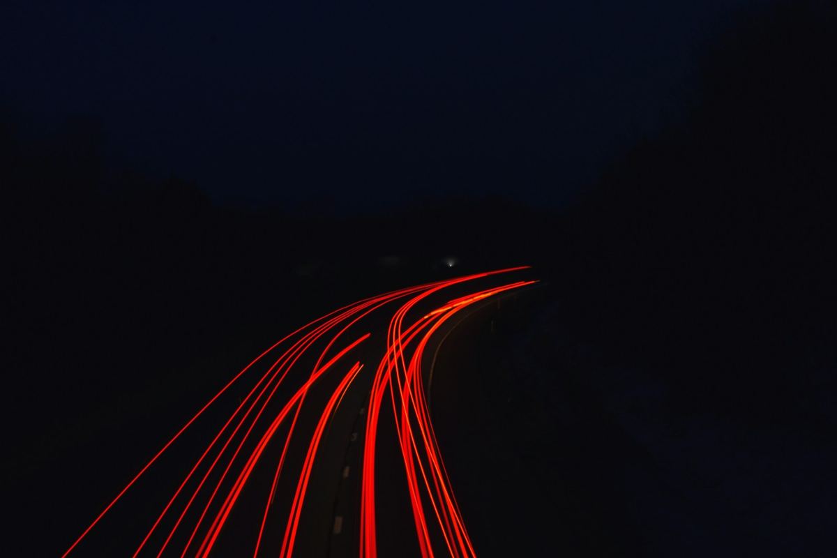 Night highway with taillight trails
